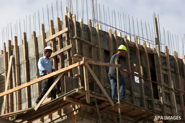 Palestinians work on a housing unit under construction site in settlement of Kiryat Arba , close to the West Bank town of Hebron , on Oct 17,2010 . Two days after reported plans to build 238 new settler homes in annexed...