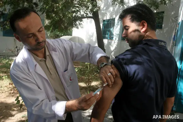 A Palestinian medical workers inject vaccination for pilgrims who want to perform the annual pilgrimage to the Muslim holy city of Mecca, in Gaza City , on Oct 19, 2010. Hundreds of Palestinian pilgrims crossed into Egyp...