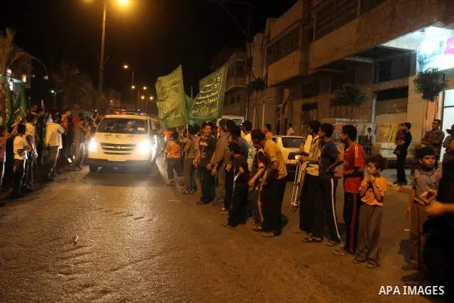 Pro-Palestinian activists recieve a cheering welcome by Palestinians upon the arrival of an aid convoy at the Rafah border crossing in the southern Gaza Strip, on 21 October 2010. An aid convoy carrying over 300 internat...