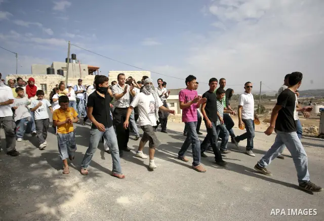 Palestinians take part in a protest in the West Bank village of Nabi Saleh, on 22 October 2010. Palestinians protest weekly against the neighbouring Jewish settlement of Halamish. Photo by Eyad Jadallah