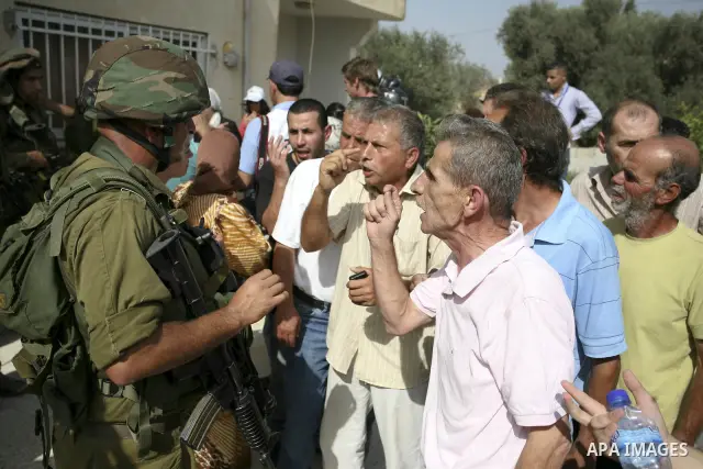 Palestinians scuffle with Israeli border policemen during clashes in the West Bank village of Nabi Saleh, on 22 October 2010. Palestinians protest weekly against the neighbouring Jewish settlement of Halamish. Photo by E...