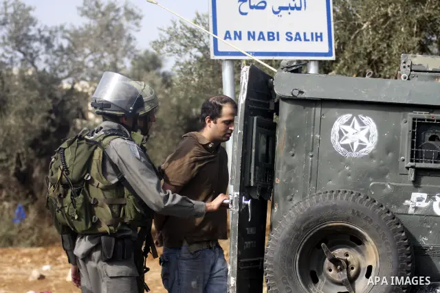 Israeli border policemen arrest two Palestinian men during clashes in the West Bank village of Nabi Saleh, on 22 October 2010. Palestinians protest weekly against the neighbouring Jewish settlement of Halamish. Photo by...