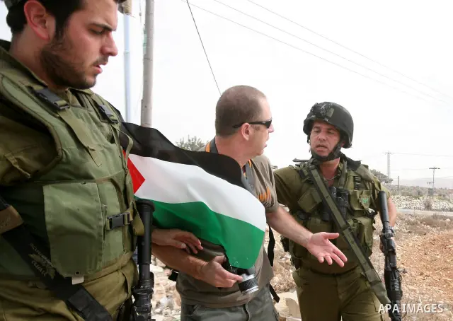 Israeli soldiers arrest a protester during a demonstration against Israel's controversial separation barrier in the West Bank village of Maasarah, near the West Bank town of Bethlehem on October 22, 2010. Photo by STR