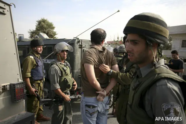 Israeli border policemen arrest two Palestinian men during clashes in the West Bank village of Nabi Saleh, on 22 October 2010. Palestinians protest weekly against the neighbouring Jewish settlement of Halamish. Photo by...