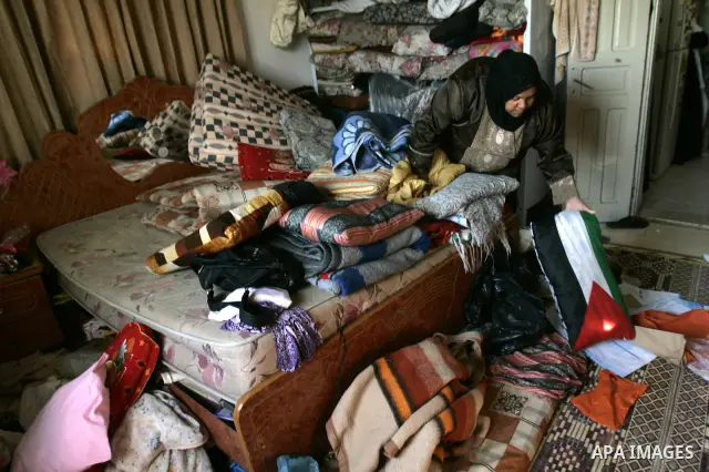 Palestinian Sahar Baida, inspect her house in the village of Jayuse in the Israeli occupied Palestinian West Bank, east of the town of Qalqilya on Oct. 25,2010, following a house-to-house search by Israeli soldiers, in w...