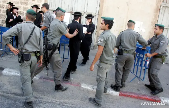 An ultra-Orthodox Jew is grabbed by an Israeli Border policeman during a protest in the coastal town of Jaffa, just south of Tel Aviv, on Oct. 25,2010 over the town's decision to remove ancient graves found during the co...
