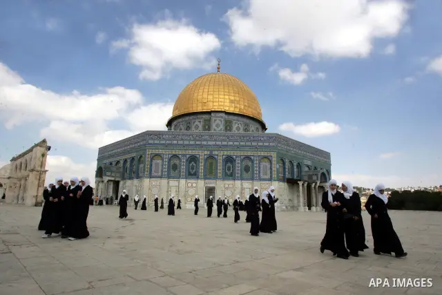 Palestinians walk in front of the Dome of Rock in the Al Aqsa Mosque compound, also known to Jews as the Temple Mount, in Jerusalem's old city on Oct. 25, 2010. Photo by Mahfouz Abu Turk