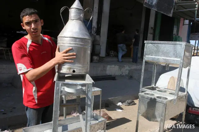 Palestinian workers make at their shop different types of pots and equipments from a special metal which was smuggled through the tunnels underground between Egypt and the southern Gaza Strip town of Rafah, in Gaza city...