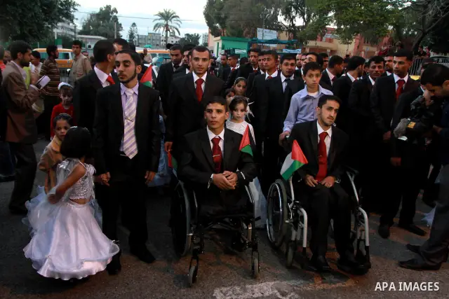 Palestinians celebrate a mass wedding held for the men wounded and made disabled during the 22 day offence by Israeli on the Gaza Strip in December 2008, in Gaza City on October 30, 2010. Photo by Ashraf Amra