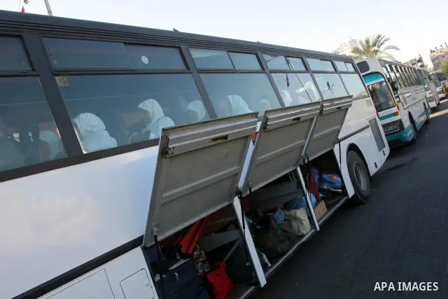 Palestinian pilgrims sit in buses as they wait to cross the Rafah border crossing into Egypt , in Gaza City on Nov. 3,2010 . Hundreds of Palestinian pilgrims crossed into Egypt on their way to Saudi Arabia to perform the...