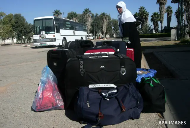 Palestinian pilgrims prepare their bags as they wait to cross the Rafah border crossing into Egypt , in the southern Gaza Strip town of Rafah on Nov. 3,2010 . Hundreds of Palestinian pilgrims crossed into Egypt on their...