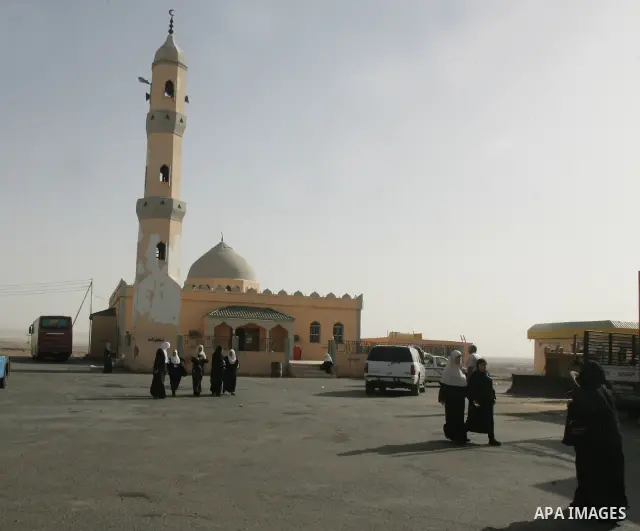 Muslim pilgrims walk outside a mosque in the Saudi holy city of Tabook on November 2, 2010. More than three million Muslims are expected to converge on the holy cities of Mecca and Medina in western Saudi Arabia for the...