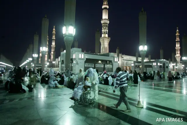 Muslim pilgrims walk outside the Prophet Mohammed Mosque in the Saudi holy city of Medina on November 3, 2010. More than three million Muslims are expected to converge on the holy cities of Mecca and Medina in western Sa...