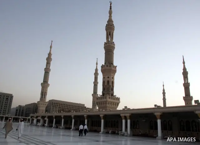 Muslim pilgrims walk outside the Prophet Mohammed Mosque in the Saudi holy city of Medina on November 4, 2010. More than three million Muslims are expected to converge on the holy cities of Mecca and Medina in western Sa...