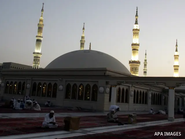 Muslim pilgrims pray outside the Prophet Mohammed Mosque in the Saudi holy city of Medina on November 4, 2010. More than three million Muslims are expected to converge on the holy cities of Mecca and Medina in western Sa...