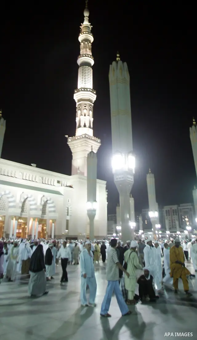 Muslim pilgrims walk outside the Prophet Mohammed Mosque in the Saudi holy city of Medina on November 4, 2010. More than three million Muslims are expected to converge on the holy cities of Mecca and Medina in western Sa...