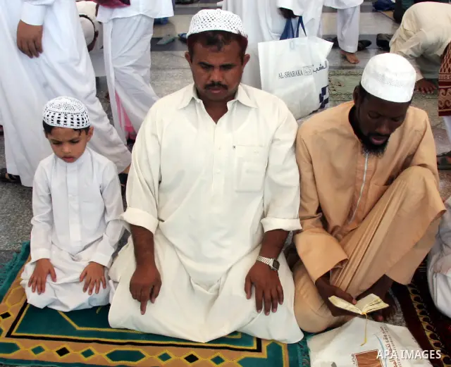 Muslim pilgrims attend Friday prayers outside the Prophet Mohammed Mosque in the Saudi holy city of Medina on November 5, 2010. More than three million Muslims are expected to converge on the holy cities of Mecca and Med...