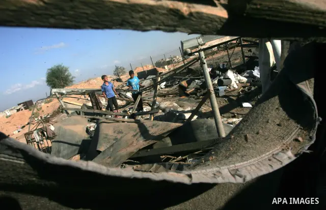 Palestinians inspect damages following Israeli raids on Rafah in the southern Gaza Strip on November 7, 2010. An Israeli air strike targeted last night the tunnels area and caused huge damage . Photo By Khaled Khaled