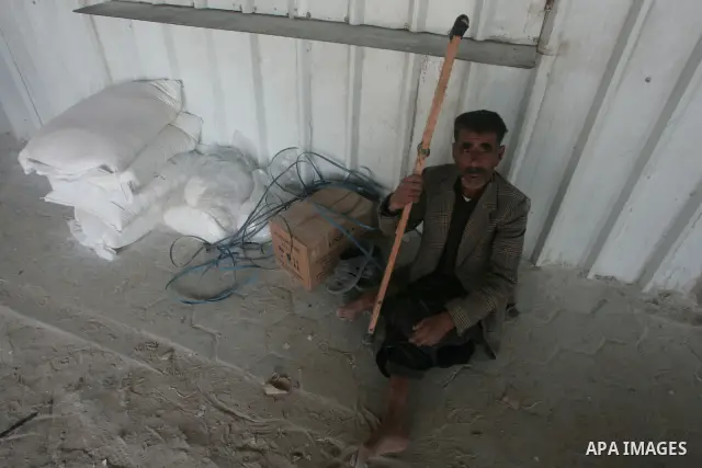 A Palestinian receives food aid from the United Nations Relief and Works Agency (UNRWA) headquarters in Rafah in the southern Gaza Strip Nov. 10, 2010 . Photo By Khaled Khaled