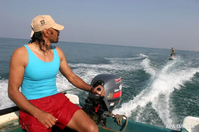 A Palestinian man teach his daughters to ride the waves sport in Gaza city beach on Nov 12,2010.. Photo by Mohammed Asad