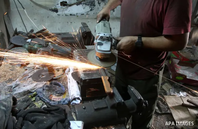 A Palestinian man sharpen knives at his workshop in Gaza city on 13 November 2010. The knives use to slaughter cattle and sheep for the Muslim holiday of Eid al-Adha or the Feast of Sacrifice, which marks the end of the...