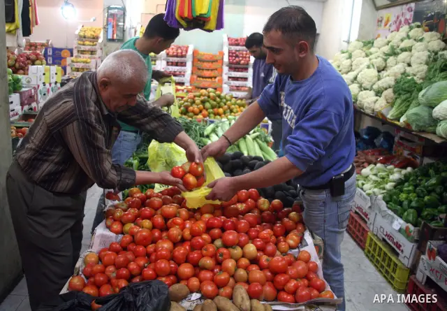 Palestinians shop at a market in the West Bank city of Hebron on 14 November 2010, in preparation for the Muslim holiday of Eid al-Adha or the Feast of Sacrifice, which marks the end of the annual pilgrimage. Photo by Na...