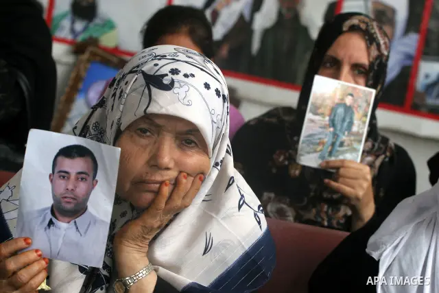 Palestinian women and children hold pictures of jailed relatives during a protest calling for the release of Palestinian prisoners from Israeli jails at the Red Cross office in Gaza City on November 15,2010 . Photo by Mo...
