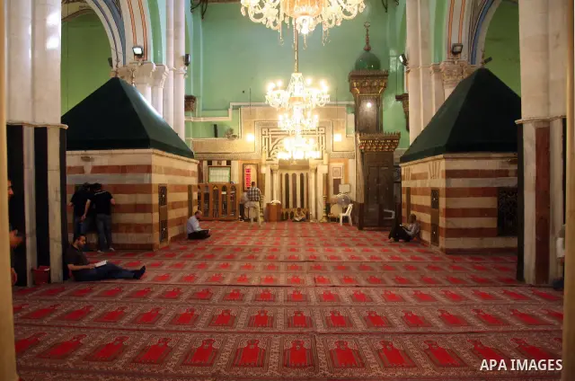 Palestinian men read Holy Koran in the Ibrahimi mosque in the old city of the West Bank city of Hebron on November 15, 2010, ahead of the Muslim holiday of Eid al-Adha or Feast of the Sacrifice, which marks the end of th...
