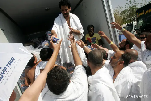 Muslim pilgrims stand at Mount Arafat, southeast of the Saudi holy city of Mecca, on November 15, 2010. Pilgrims flooded into the Arafat plain from Mecca and Mina before dawn for a key ritual around the site where prophe...