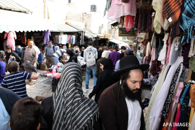 Palestinians shop at a market in the old city of Jerusalem on November 15, 2010, ahead of the Muslim holiday of Eid al-Adha or Feast of the Sacrifice, which marks the end of the annual hajj or pilgrimage to Mecca and is...