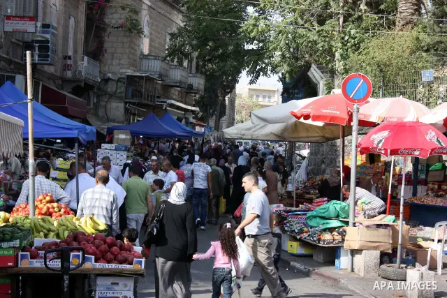 Palestinians shop at a market in the old city of Jerusalem on November 15, 2010, ahead of the Muslim holiday of Eid al-Adha or Feast of the Sacrifice, which marks the end of the annual hajj or pilgrimage to Mecca and is...
