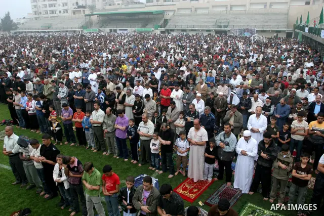 Palestinians attend a special prayer on the first day of Eid al-Adha in Gaza city on Nov.16,2010. Muslims around the world celebrate Eid al-Adha to mark the end of the haj by slaughtering sheep, goats, cows and camels to...