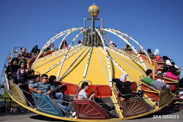 Palestinians enjoy a ride in an amusement park in the West Bank city of Ramallah on the second day of Eid al-Adha,on, November, 17, 2010. as Muslims worldwide commemorate Eid al-Adha, or the Feast of the Sacrifice, marki...