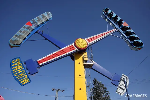 Palestinians enjoy a ride in an amusement park in the West Bank city of Ramallah on the second day of Eid al-Adha,on, November, 17, 2010. as Muslims worldwide commemorate Eid al-Adha, or the Feast of the Sacrifice, marki...