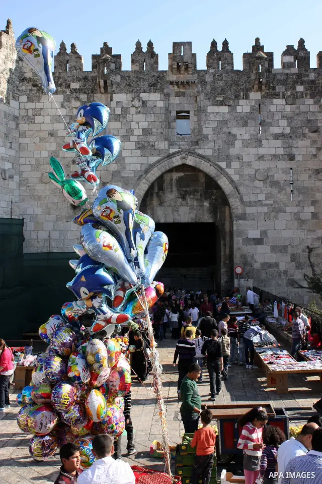 Palestinians celebrate in Jerusalem's old city on the second day of Eid al-Adha,on November, 17, 2010. as Muslims worldwide commemorate Eid al-Adha, or the Feast of the Sacrifice, marking the end of the hajj and commemor...