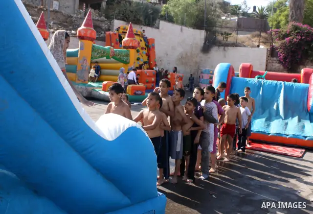 Palestinians enjoy in an amusement park in the Silwan neighborhood of East Jerusalem on the third day of Eid al-Adha,on November 18, 2010. as Muslims worldwide commemorate Eid al-Adha, or the Feast of the Sacrifice, mark...
