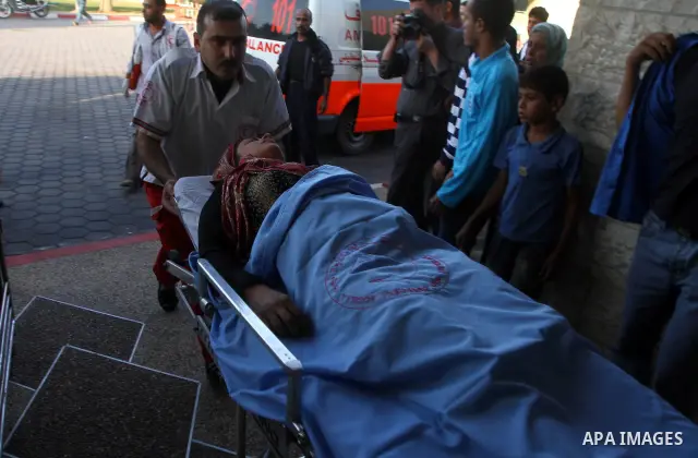 A wounded Palestinian woman is wheeled by medics into a hospital following Israeli air raids in the central town of Deir al-Balah in the Gaza Strip on November 19, 2010 after a rocket and mortars were fired into Israel f...