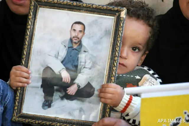 Palestinian women and children hold pictures of jailed relatives during a protest calling for the release of Palestinian prisoners from Israeli jails at the Red Cross office in Gaza City on Nov. 22,2010 . Photo by Mohamm...