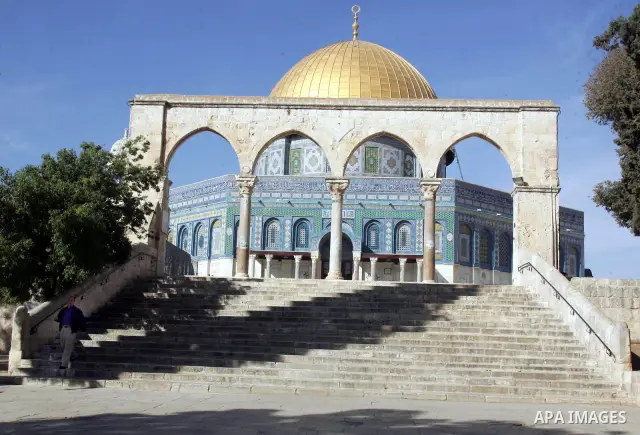 A Palestinian man walks in front of the dome of the rock at Al-Aqsa mosque in the old city of Jerusalem on Nov. 24, 2010 . Photo by Mahfouz Abu Turk
