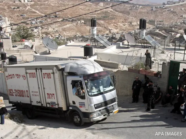 A truck passes near Israeli soldiers in Mukaber mount in the south of the old city of Jerusalem on Nov. 24,2010 . Photo by Mahfouz Abu Turk