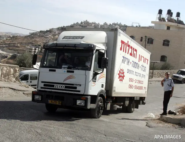 A truck passes near an Israeli soldier in Mukaber mount in the south of the old city of Jerusalem on Nov. 24,2010 . Photo by Mahfouz Abu Turk