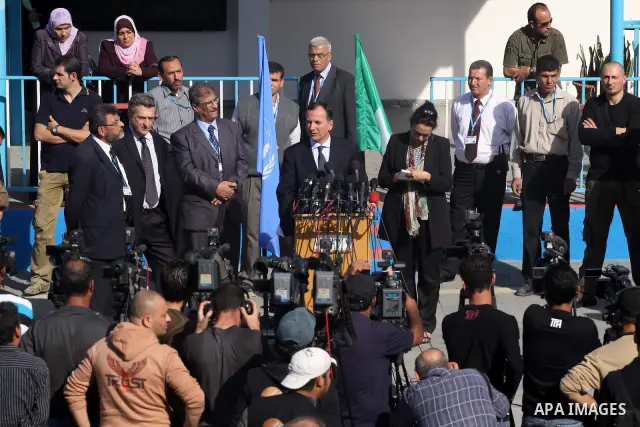 Italian Foreign Minister Franco Frattini, is accompanied by members of his delegation and security personnel during a press conference at a United Nations Relief and Works Agency (UNRWA) school in Gaza City, on 24 Novemb...