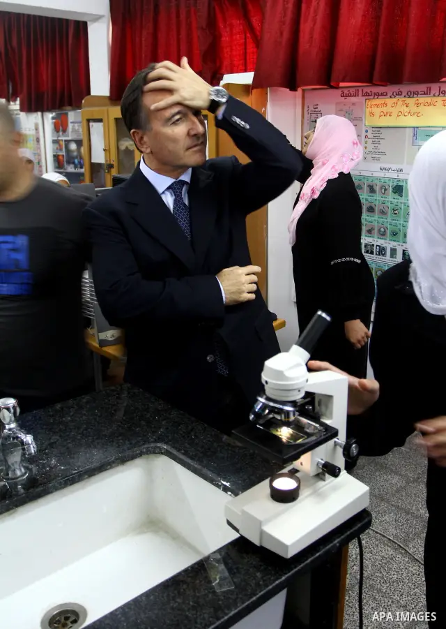 Italian Foreign Minister Franco Frattini, is accompanied by members of his delegation and security personnel as he visits a United Nations girl's school in Beit Lahia, northern Gaza Strip, on 24 November 2010. Photo by A...