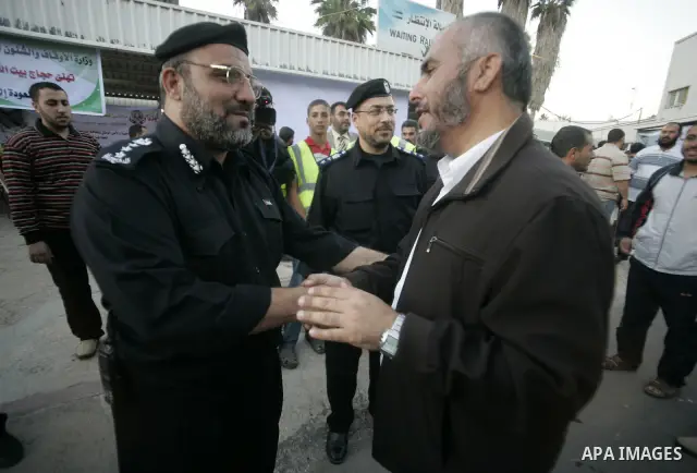 Palestinian pilgrims are welcomed by members of Hamas movement and policemen after they cross the Rafah border crossing into Gaza Strip, in the southern Gaza strip town of Rafah on Nov. 24,2010 . Hundreds of Palestinian...