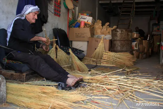 A Palestinian man weaves brooms in his shop in the middle of the market in the Old City of the West Bank city of Nablus , onThursday Nov. 25, 2010. Photo by Wagdi Eshtayah