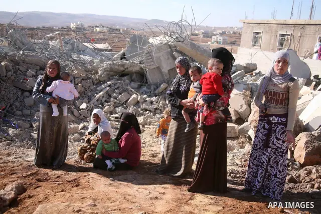 Palestinians near the rubble of their family house after it was destroyed by Israeli army tractors early on November 25, 2010 in the West Bank village of Yatta near Hebron. The house was located in the so-called Area C,...