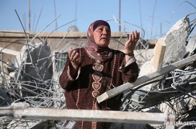 A Palestinian woman reacts near the rubble of her family house after it was destroyed by Israeli army tractors early on November 25, 2010 in the West Bank village of Yatta near Hebron. The house was located in the so-cal...