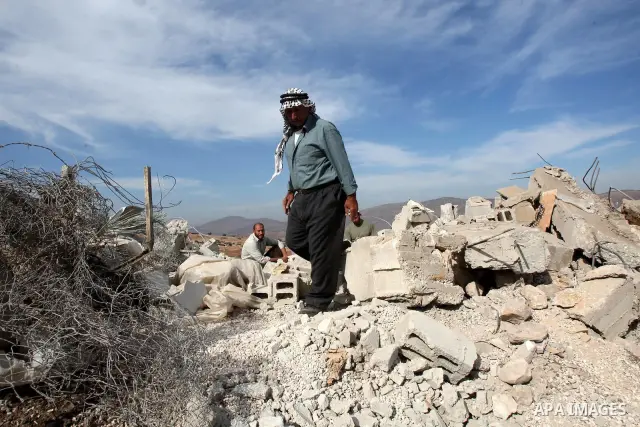 Palestinians inspect the damages in a mosque which was demolished by the Israeli army in the West Bank village of Yarza near the West Bank town of Tubas, where the army destroyed at least five buildings due to lack of Is...
