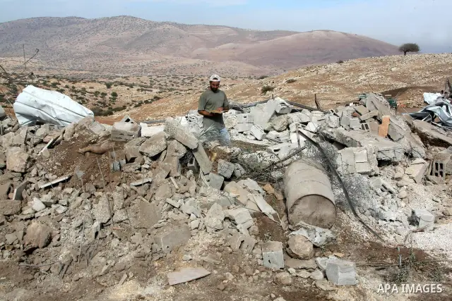 Palestinians inspect the damages in a mosque which was demolished by the Israeli army in the West Bank village of Yarza near the West Bank town of Tubas, where the army destroyed at least five buildings due to lack of Is...