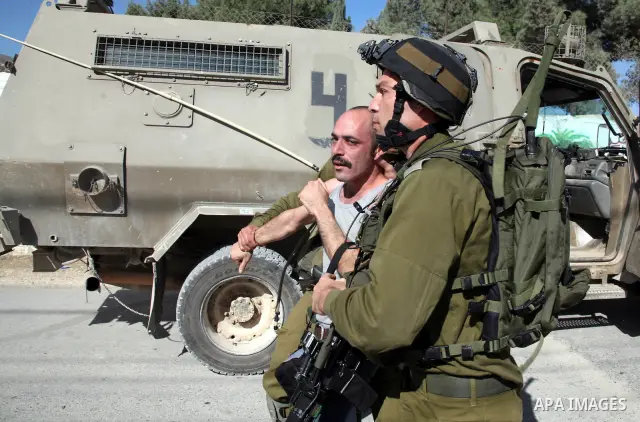 Israeli soldiers fire tear gas towards protesters during a protest against the controversial Israeli barrier in the West Bank village of al-Masarah, near Bethlehem, November 26, 2010. Israel says the barrier is needed fo...